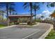 Community entrance with a stone-covered gateway and palm trees at 28375 N 130Th Dr, Peoria, AZ 85383