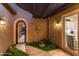 Enclosed courtyard featuring decorative details, secure gate, and view of the kitchen interior at 28375 N 130Th Dr, Peoria, AZ 85383
