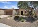 Attractive home showcasing a stone facade, desert landscaping, and well-maintained lawn at 28375 N 130Th Dr, Peoria, AZ 85383