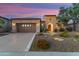 Charming home with stone accents, lush desert landscaping, and a spacious driveway at 28375 N 130Th Dr, Peoria, AZ 85383