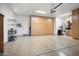 Spacious garage features ample built-in storage, epoxy flooring, and a clean, organized space for vehicles and belongings at 28375 N 130Th Dr, Peoria, AZ 85383