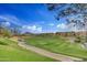 View of a golf course with mountains in the background at 28375 N 130Th Dr, Peoria, AZ 85383