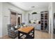 Bright kitchen featuring light colored cabinets, tiled backsplash, island and a beverage center at 28375 N 130Th Dr, Peoria, AZ 85383