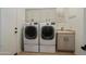 Modern laundry room featuring a front-load washer and dryer with a sink and counter space at 28375 N 130Th Dr, Peoria, AZ 85383