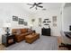 The living room features hardwood floors, a ceiling fan, and comfortable leather furniture at 28375 N 130Th Dr, Peoria, AZ 85383