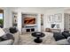 Stylish living room with built-in shelves, comfortable seating, and decorative artwork create a modern and inviting space at 28375 N 130Th Dr, Peoria, AZ 85383