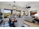 Bright living room with dining area, neutral tones, and backyard view offers a relaxing and inviting space at 28375 N 130Th Dr, Peoria, AZ 85383
