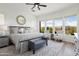 Sun-filled main bedroom with a large bed, sitting area, and views of the desert landscape at 28375 N 130Th Dr, Peoria, AZ 85383