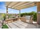 Outdoor patio area with a built-in grill under a pergola, offering a perfect space for outdoor cooking and entertaining at 28375 N 130Th Dr, Peoria, AZ 85383
