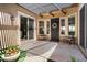 Cozy covered patio with seating, decorative wreath, and sliding glass doors to the interior at 28375 N 130Th Dr, Peoria, AZ 85383