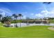 View of a pond on a golf course with palm trees at 28375 N 130Th Dr, Peoria, AZ 85383