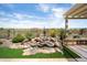 Beautiful backyard rock waterfall feature with surrounding desert landscaping creates a serene and inviting outdoor living space at 28375 N 130Th Dr, Peoria, AZ 85383