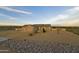 Desert home featuring a three-car garage and low maintenance landscaping at sunset at 300 W Quartz Rock Rd, Phoenix, AZ 85085