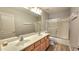 Double sink bathroom with wood cabinets and shower/tub at 3002 W Caravaggio Ln, Phoenix, AZ 85086