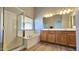 Bright bathroom features a shower, soaking tub, wood cabinets and double sinks at 3002 W Caravaggio Ln, Phoenix, AZ 85086