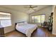 Bedroom with a queen bed, wood floors, modern ceiling fan, and natural light at 3002 W Caravaggio Ln, Phoenix, AZ 85086