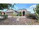 Charming home with a two-car garage, desert landscaping, and a welcoming entryway under a sunny sky at 3002 W Caravaggio Ln, Phoenix, AZ 85086