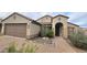 Inviting home with a two-car garage and desert landscaping along a brick walkway at 3002 W Caravaggio Ln, Phoenix, AZ 85086