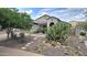 Inviting home showcasing desert landscaping with mature cacti, pavers, and a tiled roof under a partly cloudy sky at 3002 W Caravaggio Ln, Phoenix, AZ 85086