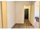 Hallway featuring modern wood floors, light, neutral walls, and bedroom access at 3002 W Caravaggio Ln, Phoenix, AZ 85086