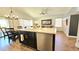 Open kitchen featuring black cabinets, white counters, stainless dishwasher, and island seating at 3002 W Caravaggio Ln, Phoenix, AZ 85086