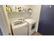 Bright laundry room with white appliances and shelving for ample storage at 3002 W Caravaggio Ln, Phoenix, AZ 85086