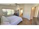 Bright main bedroom features a large window, modern ceiling fan, and ensuite bathroom access at 3002 W Caravaggio Ln, Phoenix, AZ 85086