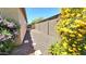 Side yard featuring gravel, stepping stones, mature landscaping, and blooming flowers at 3002 W Caravaggio Ln, Phoenix, AZ 85086