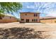 View of backyard with a dirt yard, patio area, surrounded by a block fence for privacy at 304 E Beth Dr, Phoenix, AZ 85042