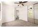 Bedroom featuring a ceiling fan, sliding closet door, and neutral carpet at 304 E Beth Dr, Phoenix, AZ 85042
