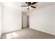 This bedroom features neutral carpet, ceiling fan, neutral paint and white trim at 304 E Beth Dr, Phoenix, AZ 85042