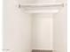 Walk in closet with carpet flooring, white walls and a metal hanging rack at 304 E Beth Dr, Phoenix, AZ 85042