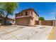 Charming two-story home featuring a red tile roof, tan stucco, and a spacious two-car garage at 304 E Beth Dr, Phoenix, AZ 85042