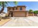 Charming two-story home featuring a red tile roof, tan stucco, and a spacious two-car garage at 304 E Beth Dr, Phoenix, AZ 85042