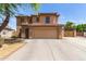 Beautiful two-story home with a spacious driveway and a tile roof, showcasing its attractive curb appeal at 304 E Beth Dr, Phoenix, AZ 85042