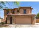 Charming two-story home featuring a red tile roof, tan stucco, and a spacious two-car garage at 304 E Beth Dr, Phoenix, AZ 85042