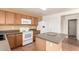 Bright kitchen featuring an island, oak cabinets, and neutral countertops at 304 E Beth Dr, Phoenix, AZ 85042