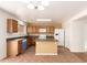 Kitchen with matching appliances, island and plenty of storage space in wooden cabinets at 304 E Beth Dr, Phoenix, AZ 85042