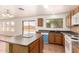 Kitchen with center island, wooden cabinets, modern appliances, and backyard access at 304 E Beth Dr, Phoenix, AZ 85042