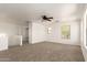 Spacious second living space with carpeted floors, a ceiling fan, and lots of natural light at 304 E Beth Dr, Phoenix, AZ 85042