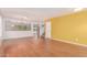 Bright living room featuring hardwood floors, a yellow accent wall and natural light throughout at 304 E Beth Dr, Phoenix, AZ 85042