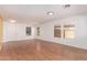 Open-concept living room featuring hardwood floors, natural light from windows, and a bright interior at 304 E Beth Dr, Phoenix, AZ 85042