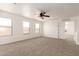 Upstairs living space with carpet, a ceiling fan, and natural light from the many windows at 304 E Beth Dr, Phoenix, AZ 85042