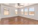 Bright living room with many windows that provide lots of natural light and lovely hardwood floors at 304 E Beth Dr, Phoenix, AZ 85042