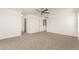 Spacious bedroom featuring a ceiling fan, carpet, and attached closet and bathroom entrances at 304 E Beth Dr, Phoenix, AZ 85042