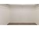 This empty walk-in closet features built-in shelving to help you stay organized at 304 E Beth Dr, Phoenix, AZ 85042