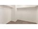 Walk-in closet with shelving, ample storage space, and neutral carpet at 304 E Beth Dr, Phoenix, AZ 85042