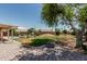 Large backyard featuring an in-ground pool, mature trees, fire pit, and landscaped area at 3059 E Tyson Ct, Gilbert, AZ 85295