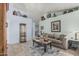 Relaxing living area with tiled floors, a comfortable sofa, and decorative accents on the walls at 3059 E Tyson Ct, Gilbert, AZ 85295