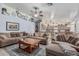Open-concept living room, attached to a kitchen, with comfortable sofas and tiled flooring at 3059 E Tyson Ct, Gilbert, AZ 85295